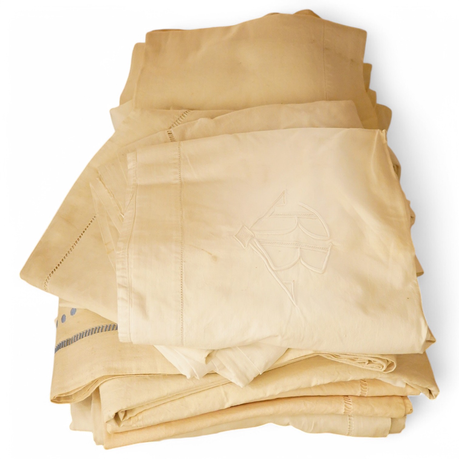 A quantity of French provincial thick linen sheets, with mostly embroidered or monogrammed turn backs (17). Condition - good